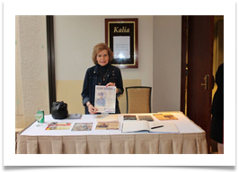 Dr. Ramsey at the reception table with a copy of the invitation/flyer